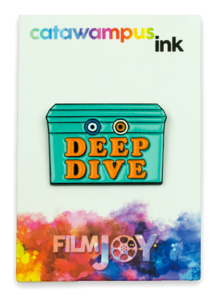 The Deep Dive enamel pin on a backing card.