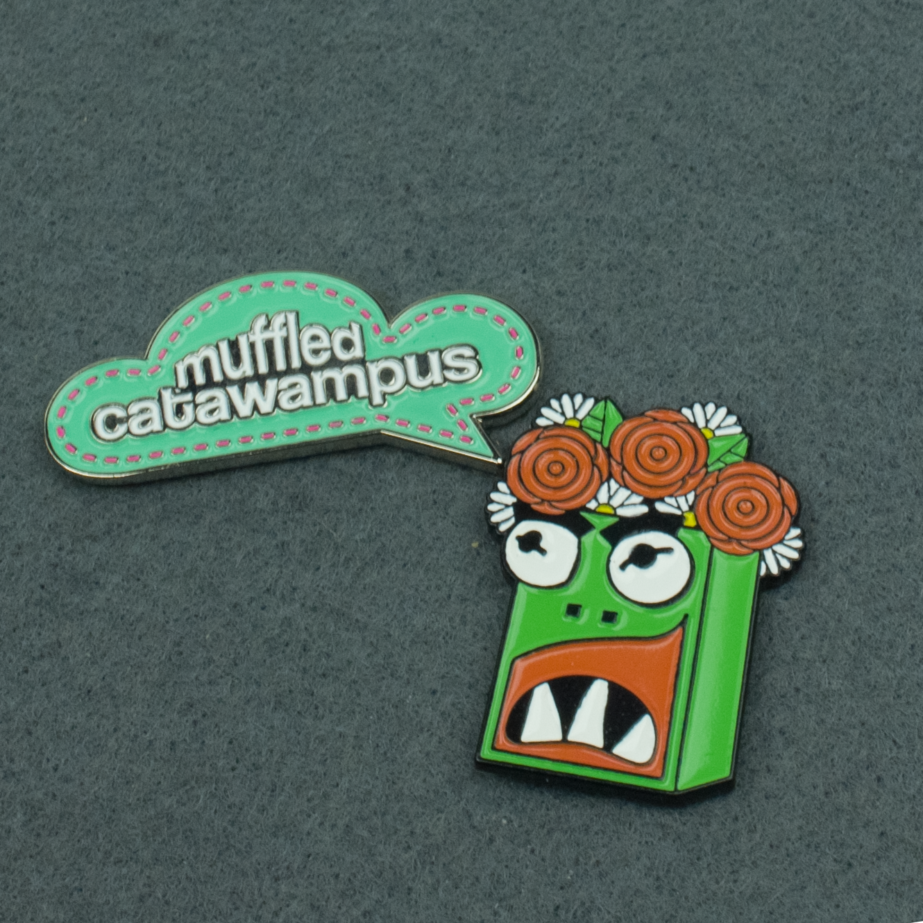 Two enamel pins that pair well together. Garry and the Muffled Catawampus thought bubble pin.